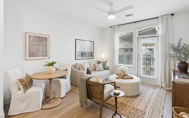 a living room with a couch, tables and chairs